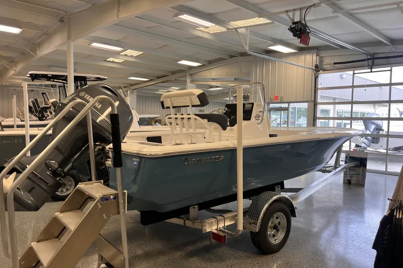 Slide: The Image of 2026 Tidewater 1910 Bay Max boat in showroom, featuring Yamaha outboard motor. - 2