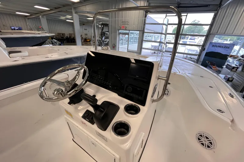 Slide: The Image of 2026 Tidewater 1910 Bay Max boat interior with steering wheel and control panel in showroom. - 5