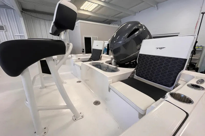 Slide: The Image of 2026 Tidewater 1910 Bay Max boat interior with seating and motor in showroom. - 6