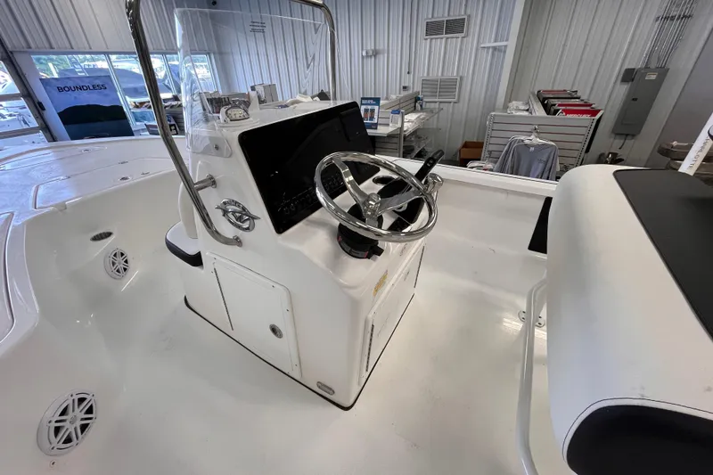 Slide: The Image of 2026 Tidewater 1910 Bay Max boat interior with steering console in showroom. - 8