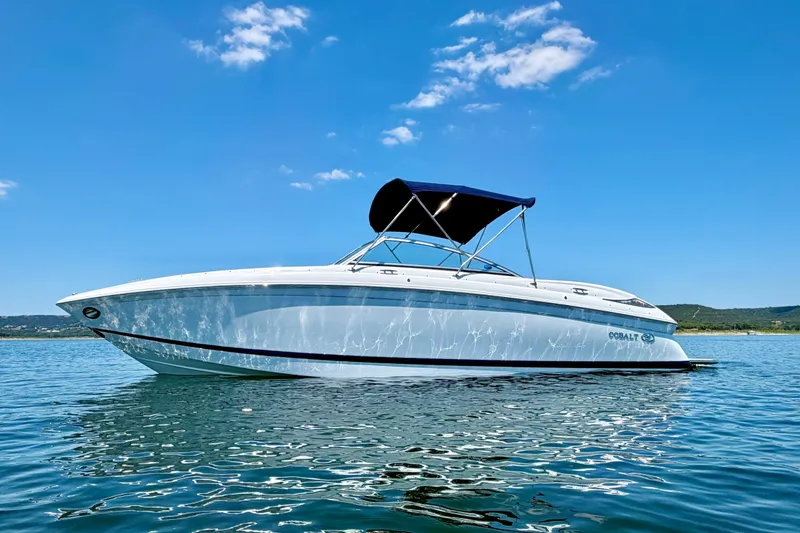 The Image of 2013 Cobalt 262 boat on calm water under clear blue sky. - 1