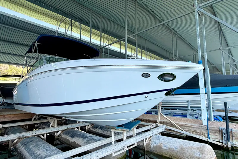 Slide: The Image of 2013 Cobalt 262 boat in covered dock, side view. - 14