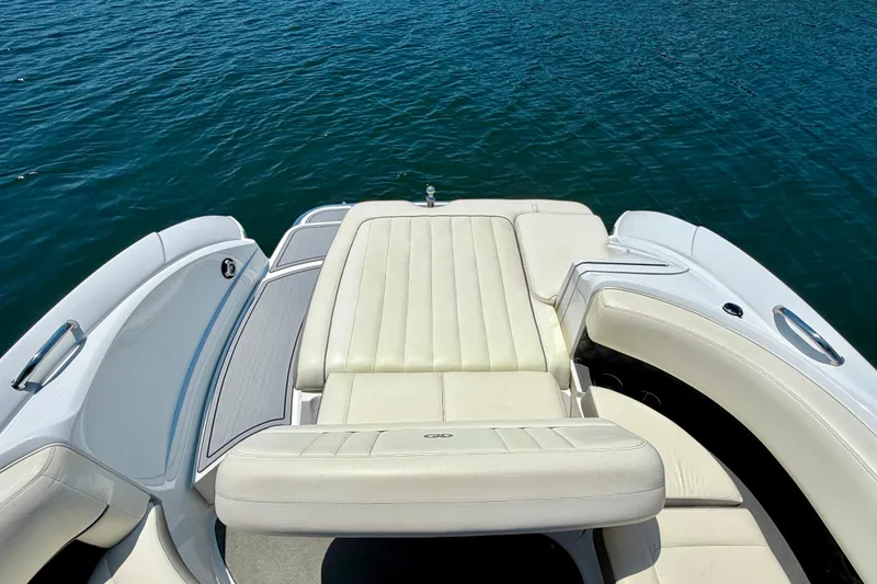Slide: The Image of 2013 Cobalt 262 boat with white seating on calm blue water. - 25