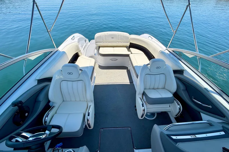 Slide: The Image of Interior of a 2013 Cobalt 262 boat with luxurious seating on calm water. - 27