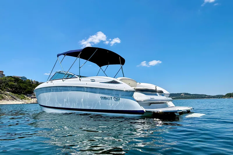 Slide: The Image of 2013 Cobalt 262 boat on a sunny lake with clear blue skies. - 3