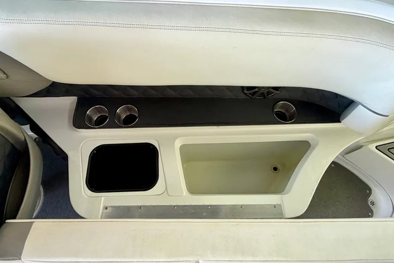 Slide: The Image of Interior of a 2013 Cobalt 262 boat featuring cup holders and storage compartments. - 39