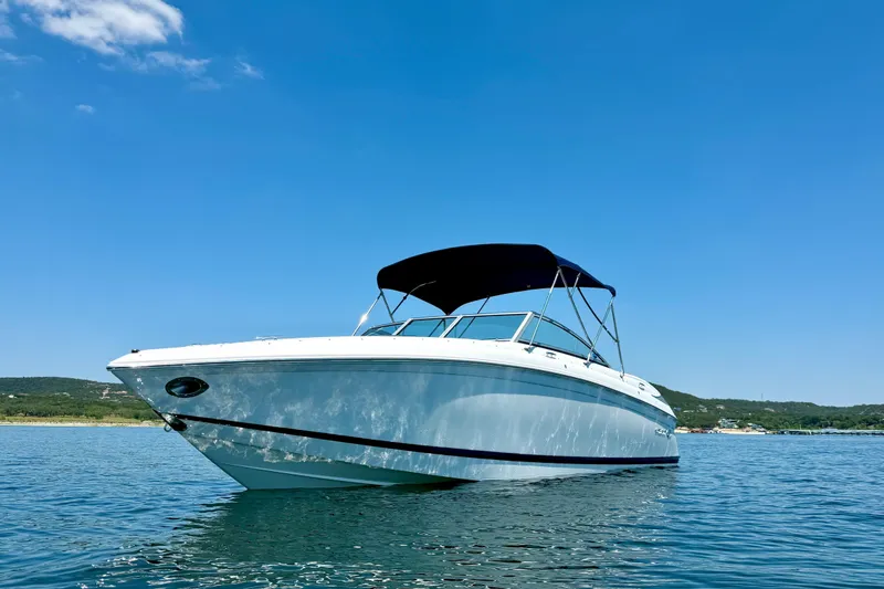 Slide: The Image of 2013 Cobalt 262 boat on calm water under clear blue sky. - 4