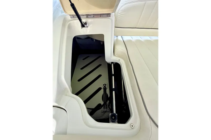 Slide: The Image of Open storage compartment in 2013 Cobalt 262 boat with white interior. - 41