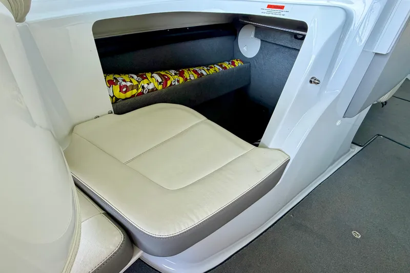 Slide: The Image of 2013 Cobalt 262 boat interior with white seating and storage compartment. - 42