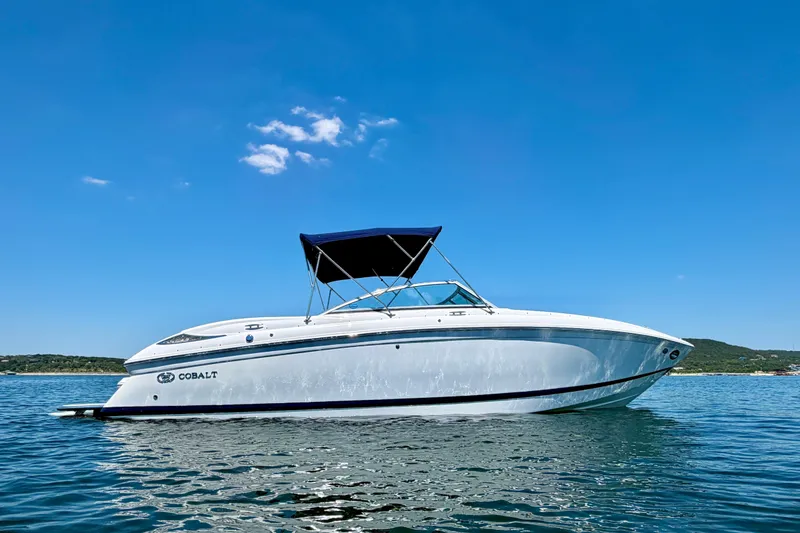 Slide: The Image of 2013 Cobalt 262 boat on calm water under clear blue sky. - 5