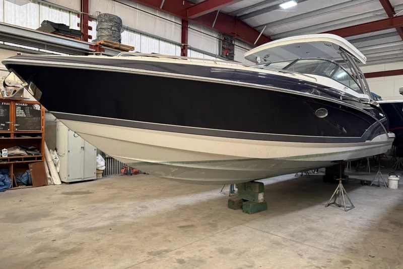 Slide: The Image of 2016 Formula 350 Crossover Bowrider in a storage facility, elevated on supports. - 1