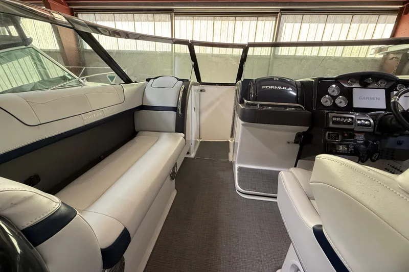 Slide: The Image of 2016 Formula 350 Crossover Bowrider interior with white seating and modern dashboard. - 18