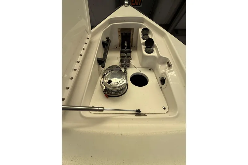 Slide: The Image of 2016 Formula 350 Crossover Bowrider anchor compartment with winch and storage features. - 29