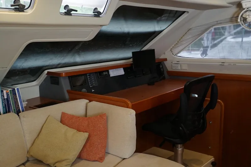 Slide: The Image of Interior of 2007 Leopard 46 yacht with navigation station and cozy seating area. - 10