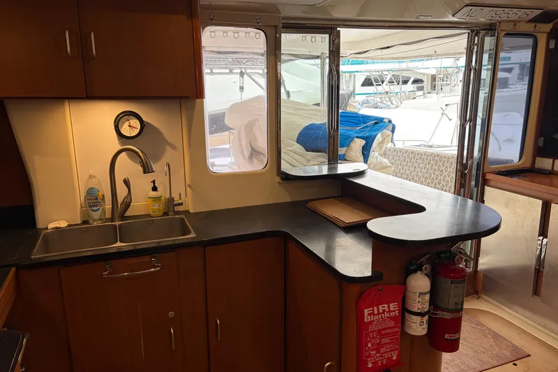 Slide: The Image of Interior of a 2007 Leopard 46 yacht kitchen with sink, counter, and fire safety equipment. - 13