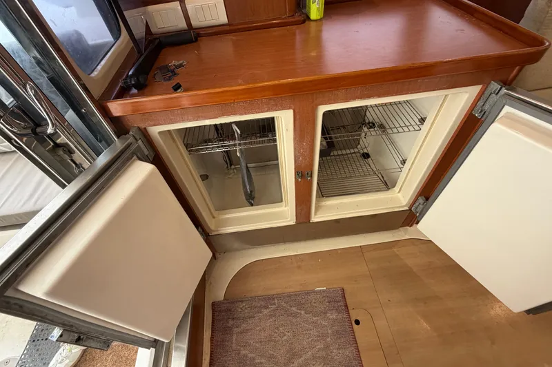 Slide: The Image of Interior of a 2007 Leopard 46 yacht showing open cabinets and countertop. - 15
