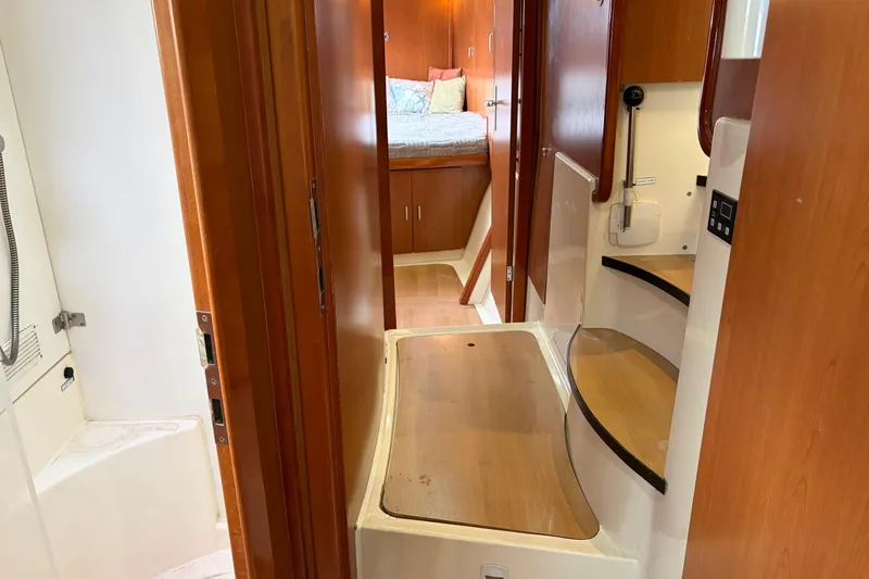 Slide: The Image of Interior of 2007 Leopard 46 yacht featuring wooden cabinetry and cozy sleeping area. - 16