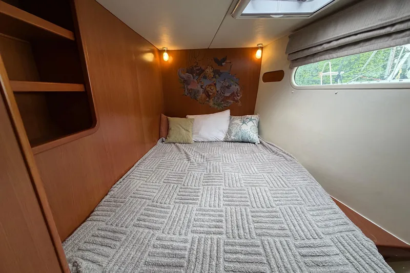 Slide: The Image of Cozy cabin interior of 2007 Leopard 46 yacht with bed and decorative pillows. - 19