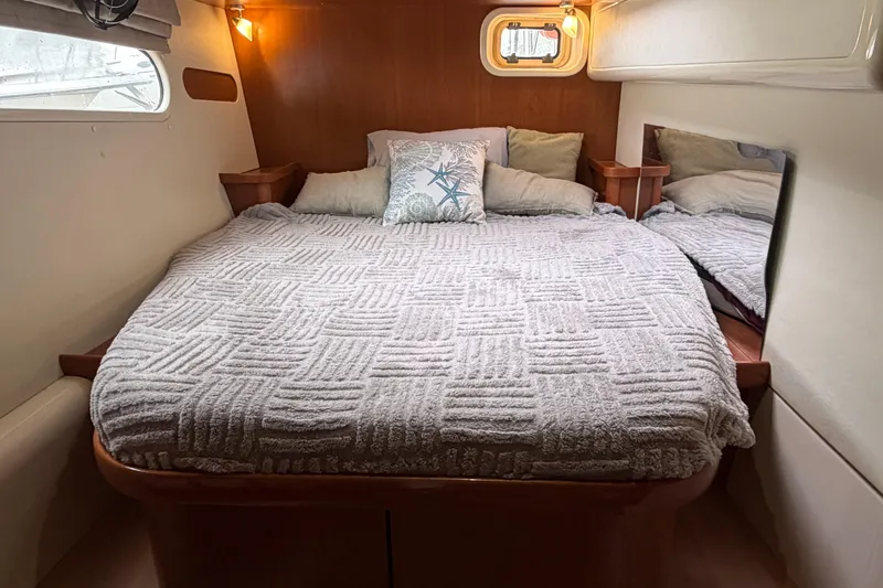 Slide: The Image of Cozy bedroom in 2007 Leopard 46 yacht with plush bedding and soft lighting. - 21