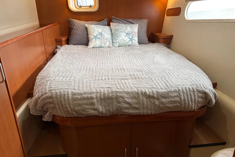 Slide: The Image of Cozy bedroom in 2007 Leopard 46 yacht with plush bedding and decorative pillows. - 23