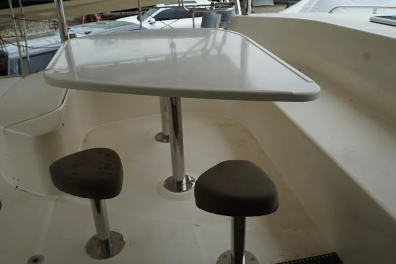 Slide: The Image of 2007 Leopard 46 yacht cockpit with table and stools, showcasing sleek design and functionality. - 28