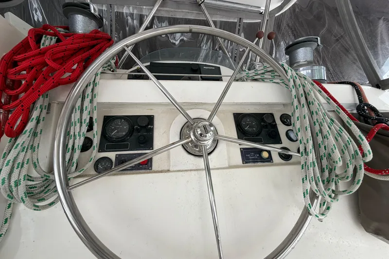 Slide: The Image of Steering wheel of a 2007 Leopard 46 yacht with ropes and navigation instruments. - 30