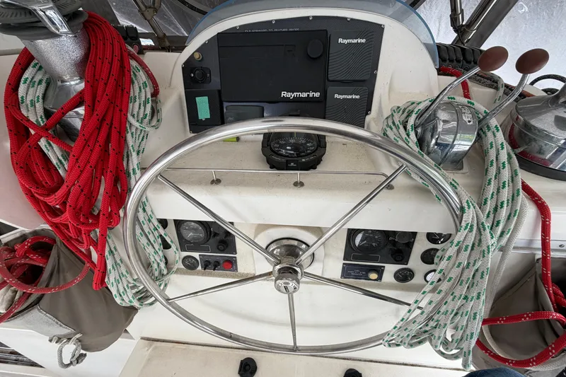 Slide: The Image of Steering wheel and controls of a 2007 Leopard 46 yacht with ropes and navigation equipment. - 31