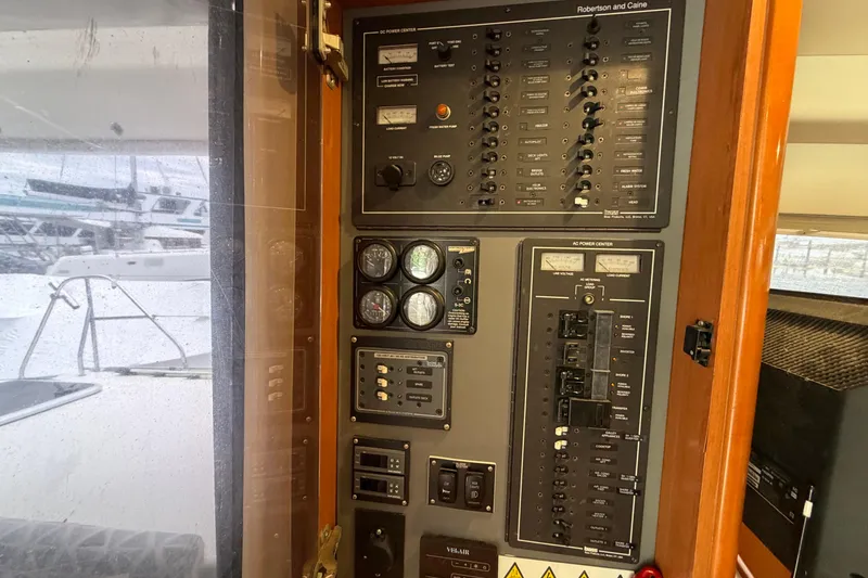 Slide: The Image of Electrical control panel on a 2007 Leopard 46 yacht, featuring various switches and gauges. - 32