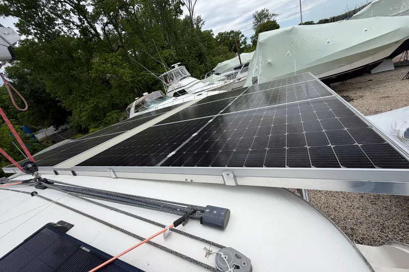 Slide: The Image of Solar panels on a 2007 Leopard 46 yacht, docked with other boats nearby. - 37