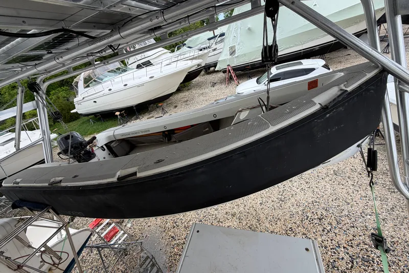 Slide: The Image of Hanging Leopard 46 boat from 2007 in storage, surrounded by other boats and vehicles. - 38
