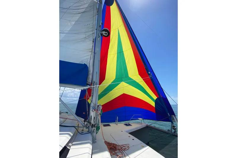 Slide: The Image of Colorful sail on a 2007 Leopard 46 catamaran against a clear blue sky. - 43