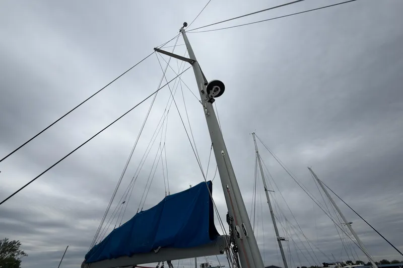 Slide: The Image of Sailboat mast with blue cover under cloudy sky, Leopard 46, 2007 model. - 45