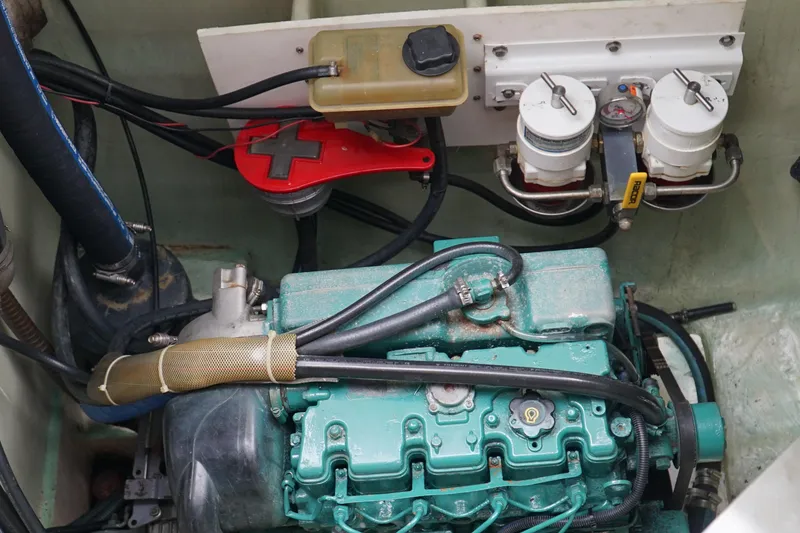 Slide: The Image of Engine compartment of a 2007 Leopard 46 yacht, featuring a green engine and fuel filters. - 52