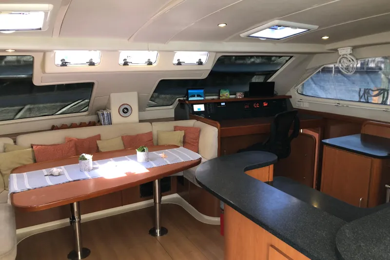 Slide: The Image of Luxurious interior of a 2007 Leopard 46 yacht with modern seating and navigation area. - 8