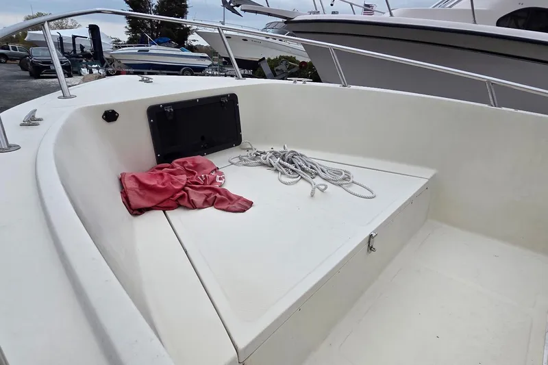 Slide: The Image of 1995 Sportsman Island Reef 19 Center Console boat deck with ropes and a red cloth. - 10
