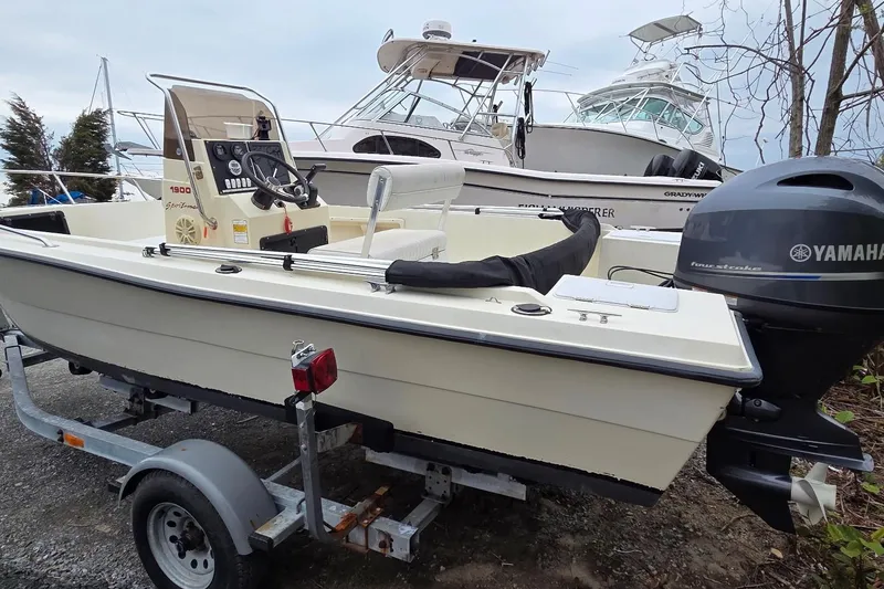 Slide: The Image of 1995 Sportsman Island Reef 19 Center Console boat on trailer with Yamaha outboard motor. - 3