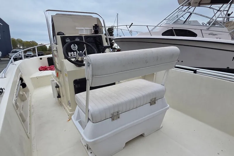Slide: The Image of 1995 Sportsman Island Reef 19 Center Console boat interior with steering wheel and seating. - 4