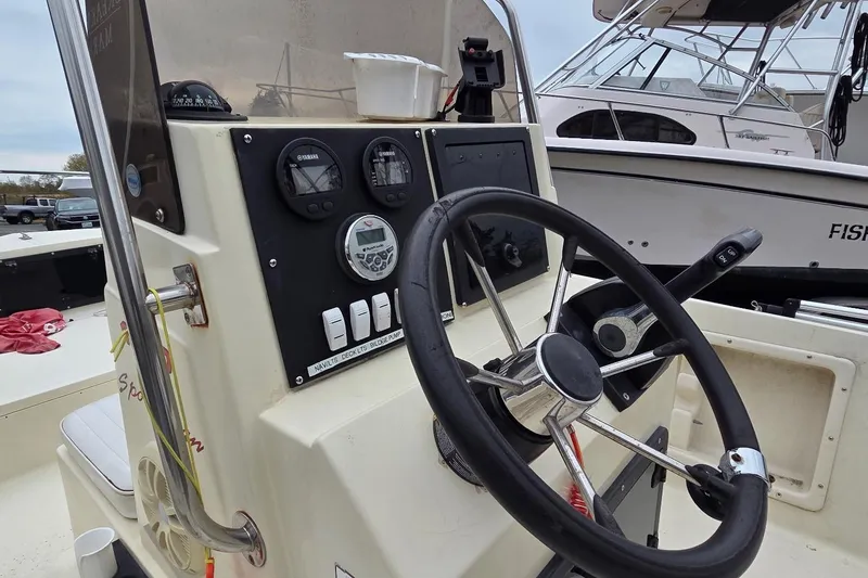 Slide: The Image of 1995 Sportsman Island Reef 19 Center Console boat dashboard with steering wheel and gauges. - 5