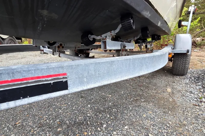 Slide: The Image of Trailer supporting a 1995 Sportsman Island Reef 19 Center Console boat on gravel. - 8