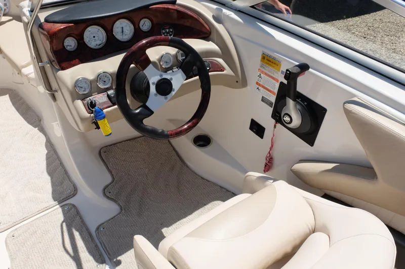 Slide: The Image of 2006 Glastron GXL 205 boat interior with steering wheel and control panel. - 11