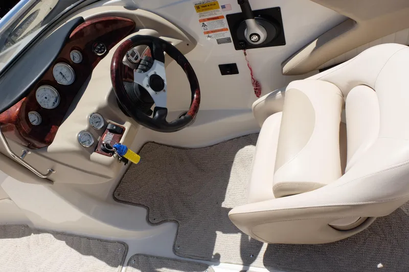 Slide: The Image of 2006 Glastron GXL 205 boat interior with steering wheel and gauges. - 12