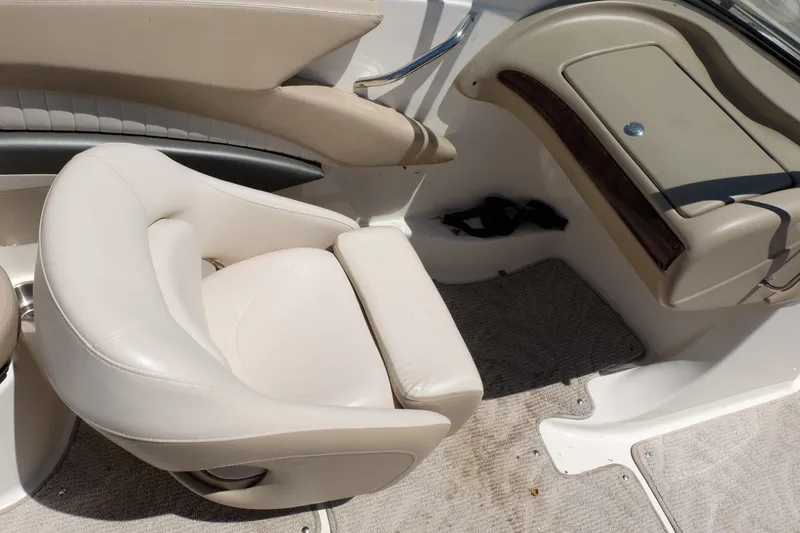 Slide: The Image of 2006 Glastron GXL 205 boat interior with beige seating and dashboard. - 13