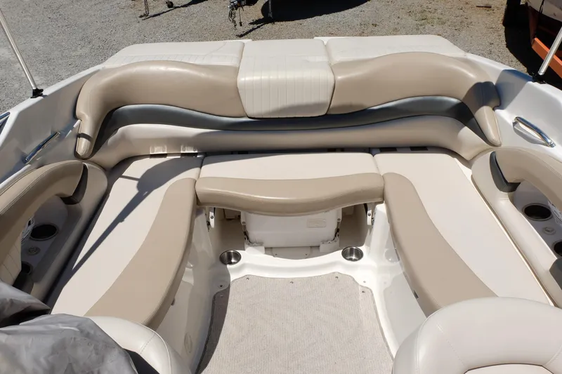 Slide: The Image of 2006 Glastron GXL 205 boat interior with beige seating and cup holders. - 14