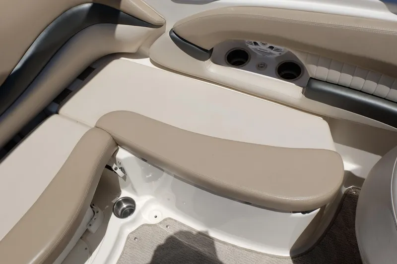 Slide: The Image of 2006 Glastron GXL 205 boat interior with beige seating and cup holders. - 15