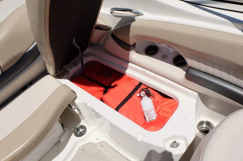 Slide: The Image of 2006 Glastron GXL 205 boat storage compartment with life jackets and fire extinguisher. - 16