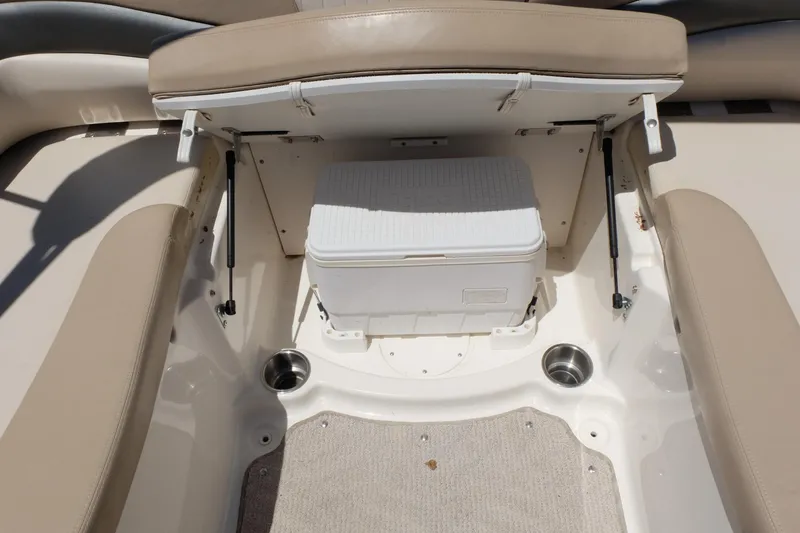 Slide: The Image of 2006 Glastron GXL 205 boat interior with storage compartment and cooler. - 17