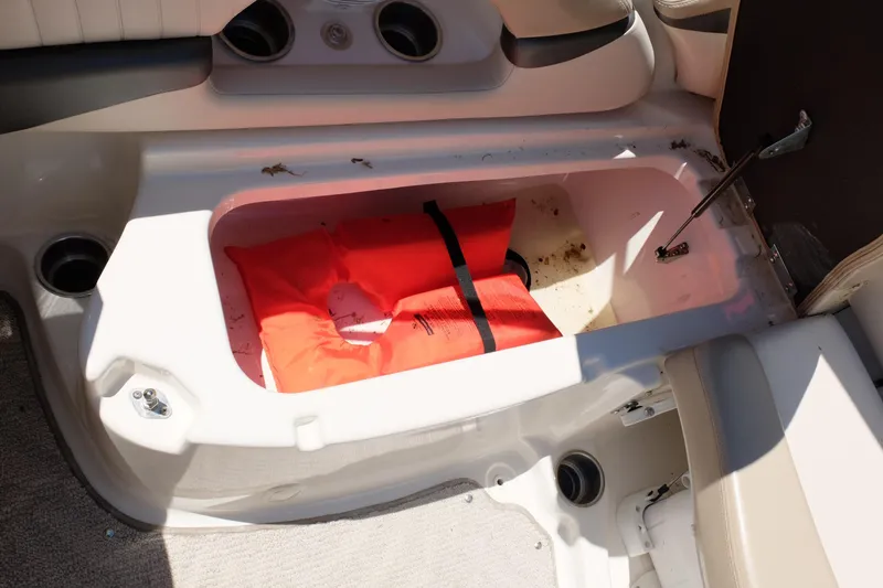 Slide: The Image of Storage compartment in a 2006 Glastron GXL 205 boat with an orange life jacket. - 18