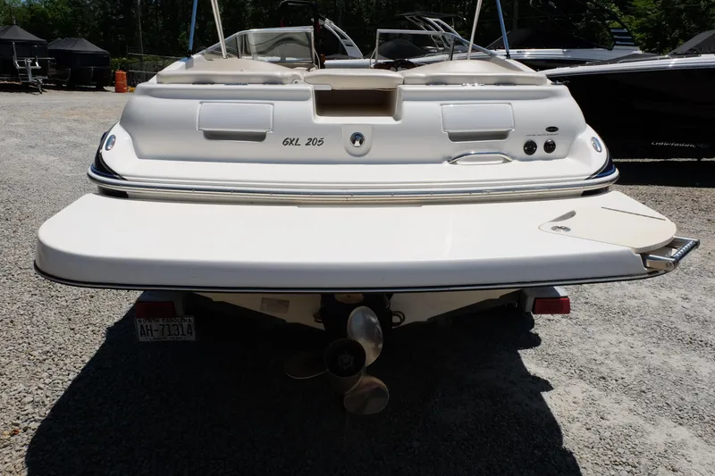 Slide: The Image of 2006 Glastron GXL 205 boat rear view, showcasing swim platform and propeller. - 2