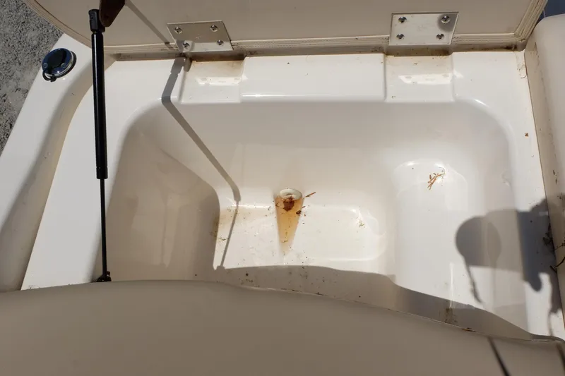 Slide: The Image of Open storage compartment in 2006 Glastron GXL 205 boat, showing interior details. - 21