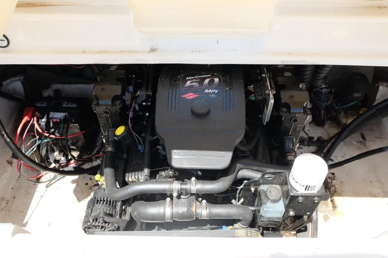 Slide: The Image of Engine compartment of a 2006 Glastron GXL 205 boat, featuring a MerCruiser 5.0 MPI engine. - 24